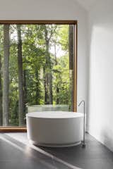 The master bathroom features an Agape tub with a Watermark filler.