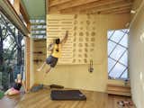 A climbing wall on the ground floor mimics the playful atmosphere of a children's tree house.