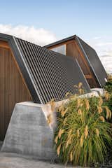 Outdoor, Shrubs, and Retaining Fences, Wall The retaining wall anchors the standing-seam steel roof.  Photos from This Bunker-Like Home in New Zealand Fights Back Against Howling Winds Off Lake Wanaka