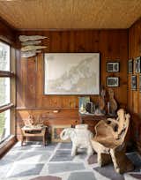 The sunroom—or “museum of natural history,” as the couple call it—showcases an array of objects, including a massive chair carved from a single tree trunk and a terra cotta elephant used as a side table.
