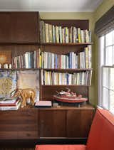 In the library, a walnut shelving unit by Poul Cadovius faces a sofabed from CB2. Among the items on display is a motorized model fire boat built by Francine’s late father. “It’s what you do when you’re a retired engineer with time on your hands,” Francine explains.