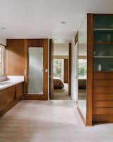 Bath, Enclosed, Recessed, Porcelain Tile, and Drop In In the master bathroom and dressing room, pink-and-white floor tiles were found hidden under ’70s shag carpeting.  Bath Porcelain Tile Drop In Recessed Photos from This Michigan Couple Found Out They Own the Last Standing Home by Alexander Girard