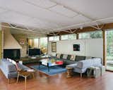 Living, Corner, Coffee Tables, Track, Sofa, Medium Hardwood, Sectional, End Tables, and Rug  Living Coffee Tables Corner Medium Hardwood Sofa Photos from This Michigan Couple Found Out They Own the Last Standing Home by Alexander Girard