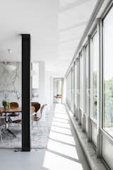 The drafty windows on the south facade all had to go. “That alone cost more than my previous house,” says Simon. “The heritage people wanted the glass to have the same shine and coloration.”  Photo 7 of 36 in A Major Restoration Updated This Midcentury Landmark in Belgium