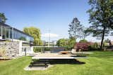 Much of the concrete and metalwork for the multilevel, L-shaped terrace had to be  redone. The Pantagruel picnic table is by Dirk Wynants for Extremis; the 1966 Adjustable Chaises are by Richard Schultz for Knoll.