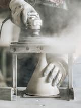 8. Trim the Top: Radu uses a jig and angle grinder to trim the stem to the correct height.