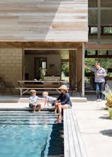 Outdoor, Back Yard, Concrete Patio, Porch, Deck, and Swimming Pools, Tubs, Shower The outdoor seating area provides ample space to entertain family and friends.  Photo 7 of 10 in New York Architect John Berg Invites Us Into His Indoor/Outdoor Hamptons Home