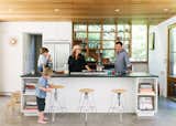 Kitchen, Cooktops, Concrete Floor, Refrigerator, Recessed Lighting, and White Cabinet In the Berg household, the kitchen is the epicenter of the home.  Photo 5 of 10 in New York Architect John Berg Invites Us Into His Indoor/Outdoor Hamptons Home
