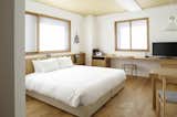 Bedroom, Chair, Medium Hardwood Floor, Pendant Lighting, Bed, and Recessed Lighting  Photo 2 of 12 in Claska Hotel by Dwell