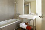 Bath Room, Full Shower, Whirlpool Tub, Wall Mount Sink, Alcove Tub, and Drop In Sink  Photo 3 of 12 in Claska Hotel by Dwell