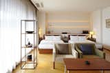 Bedroom, Table Lighting, Bed, Medium Hardwood Floor, Chair, and Night Stands  Photo 8 of 12 in Claska Hotel by Dwell