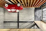 Vehicle Wall Art supplied the loft’s most unusual feature, a 1965 Fiat Nuova 500 F mounted upside-down on the ceiling. Magnetic panels of blackened and waxed steel display smaller artworks. The floating stairs replaced a ramshackle set of steps.

