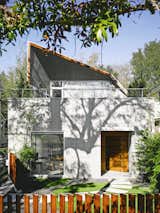 The transformation of  a 1950s eyesore into an elegant, gallery-like home was a creative challenge for architect Kevan Hoertdoerfer and all involved. The poem “Roll the Dice” by Charles Bukowski is painted on the facade. “It expresses how we  felt about the project,” says resident Karen Baldwin. “Everybody  roll with it—everybody do their thing.”