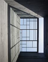 Windows, Skylight Window Type, and Metal A dramatic stairwell rises through the center of architect Mehdi Berrada’s bold new home in Casablanca. At the top, a steel-framed retractable skylight casts graphic shadows.  Photo 2 of 15 in A Modernist Cube Rises in the Ancient City of Casablanca