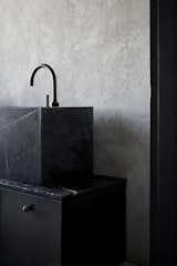 Bath Room, Marble Counter, Drop In Sink, and Concrete Wall “Black is not dark. It’s not sad. It absorbs the light and lets you see details,” says Mehdi.  Photos from A Modernist Cube Rises in the Ancient City of Casablanca