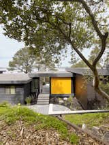 Exterior, Metal, Flat, Wood, House, and Mid-Century MDO panels the color of California poppies accent the home’s exterior.  Exterior Metal Wood House Flat Mid-Century Photos from An Addition to a 1955 Modern Home Maximizes Views of the San Francisco Bay