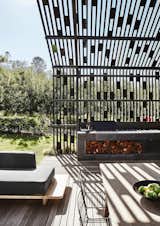 Outdoor, Wood Patio, Porch, Deck, Large Patio, Porch, Deck, Wood Fences, Wall, and Front Yard He devised the pergola to break up the mass of the house and integrate it into the site.  Photo 5 of 12 in A Hotelier Riffs on a Traditional Barn for His Family’s Retreat in South Africa