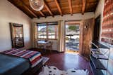 Bedroom, Pendant Lighting, Chair, Rug Floor, and Bed  Photo 5 of 9 in Pioneertown Motel by Dwell