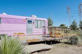 The Vagabond Trailer at El Cosmico features a pink exterior and restored, marine-varnished birch interiors.