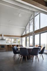 The dining room suspension light is a custom design by Robert Franco. The dining chairs are by West Elm.