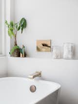 The tub has a tap by Delta Faucet.