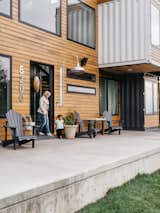 Exterior, Shipping Container, and Wood A concrete patio wraps around the house.  Exterior Shipping Container Wood Photos from A Colorado Firefighter Built His Own Shipping Container Home, and Found a New Calling Along the Way