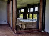 In the master bathroom, oversized windows and an Agape mirror pull the outside in.