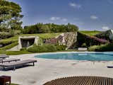 Outdoor, Shrubs, Flowers, and Small Pools, Tubs, Shower The limestone-encircled pool was updated as part of a broader landscape renovation.  Search “flower-arranging-at-icff.html” from An Architect Unites Three Brutalist Villas He Designed on Sardinia in the 1970s