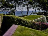 Outdoor, Flowers, Rooftop, and Grass The roofs are planted with rosemary, myrtus, westringia, and more.  Photos from An Architect Unites Three Brutalist Villas He Designed on Sardinia in the 1970s