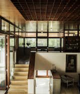 Staircase and Wood Tread The sunken living room is illuminated by an eight-by-eight-foot gridded skylight in the copper ceiling.  Photo 5 of 18 in An Austrian Family Embraces a Plush 1970s Home in Need of a Little Love