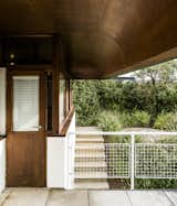 Exterior, House Building Type, and Curved RoofLine The home has more than a hundred mahogany-framed windows—many of which needed to be updated—sheltered by four-foot overhangs.  Photo 9 of 18 in An Austrian Family Embraces a Plush 1970s Home in Need of a Little Love