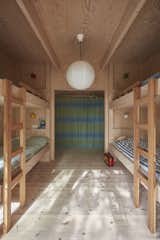 Kids, Bedroom, Bunks, Bed, Neutral, and Light Hardwood The built-in plywood bunks in the children’s room were designed by STEG.  Kids Neutral Light Hardwood Bunks Photos from A Pint-Sized, No-Frills Summerhouse Rises From the Rocks on a Swedish Island