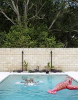 A Jeff Koons lobster joins a float by the artist KAWS in the pool.