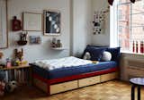 In Anatole’s room, a metal Min bed by Luciano Bertoncini for Design Within Reach has storage added underneath it. OvAbove the desk is a 1970s illustration by Jean-Michel Folon.