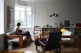 Luise Stauss, a former photo editor at The New York Times Magazine, sits in the living room of the downtown Brooklyn apartment she shares with her husband, Nicholas Blechman, the creative director of The New Yorker. The roughly 1,000-square-foot space feels larger than it is, thanks to high ceilings and bay windows. Twin 1962 Bastiano sofas by Tobia Scarpa are joined by a Cité chair by Jean Prouvé and a wood chair acquired from the New York Historical Society. The floor lamp is by David Weeks Studio.