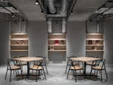 Living Room, Track Lighting, Shelves, Table, and Chair  Photo 19 of 20 in The Share Hotels Rakuro by Dwell