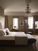 Bedroom, Bench, Light Hardwood Floor, Floor Lighting, Bed, Rug Floor, Table Lighting, and Chair  Photos from Ett Hem