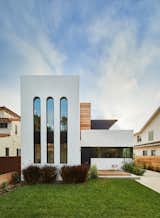 The building's crisp, white facade nods to the neighboring white stucco homes that were constructed in the 1920s and 1930s. The elongated arched windows give the exterior a 1920s Art Deco feel.