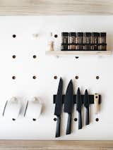 A space-efficient custom pegboard holds Crow Canyon enamel mugs and more.