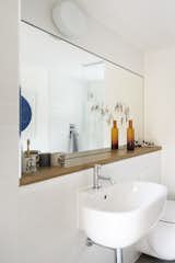 In the bathroom, a Zyam tap by Aston Matthews is mounted on a Series 500 sink by Antonio Citterio for Pozzi-Ginori.