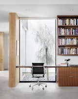 Facing another courtyard, an office nook features a Caesarstone countertop and walnut built-ins by Austin Wood Work. 