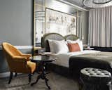 Bedroom, Chair, Pendant Lighting, Rug Floor, Bed, Medium Hardwood Floor, and Night Stands  Photo 3 of 11 in Sir Savigny Hotel by Dwell