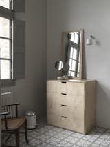 A chest of drawers by Isokon Plus, as well as a Vipp pedal bin and sconce,