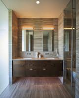 Bath, Drop In, Medium Hardwood, and Ceiling The master bathroom is wrapped in tk tk.  Bath Medium Hardwood Drop In Photos from The Firm Behind the Legendary Apple Store Reimagines a Nike VP’s 1950s Home