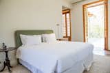 Bedroom, Rug Floor, Medium Hardwood Floor, Night Stands, and Bed  Photo 14 of 14 in Casa Marques Jardim Botanico by Dwell