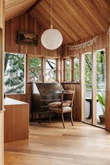 Bedroom, Medium Hardwood, Storage, Chair, Pendant, and Dresser  Bedroom Medium Hardwood Storage Dresser Pendant Photos from This Light-Filled Bungalow Exudes Playful Tree House Vibes
