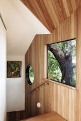 Windows and Picture Window Type A painting by Fleur’s mother is displayed on the stair.  Photos from This Light-Filled Bungalow Exudes Playful Tree House Vibes