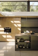 Kitchen, Wood Cabinet, Wall Oven, Ceiling Lighting, Cooktops, and Concrete Floor  Photo 14 of 162 in Design Guides by Sandeep Thomas from This Meditative Home in Silicon Valley Offers Garden Views at Every Turn