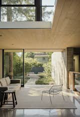 Living Room, Concrete Floor, Chair, Ceiling Lighting, Sofa, and End Tables  Photo 15 of 162 in Design Guides by Sandeep Thomas from This Meditative Home in Silicon Valley Offers Garden Views at Every Turn