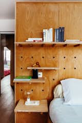 The pegs in the master bedroom can be rearranged to alter the layout of shelves, allowing flexible storage options.